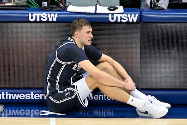 Duke guard Cooper Flagg (2) sits on the floor as he waits to enter an NCAA college basketball game against SMU during the second half Saturday, Jan. 4, 2025, in Dallas. Duke wins 89-62. (AP Photo/Jerome Miron)