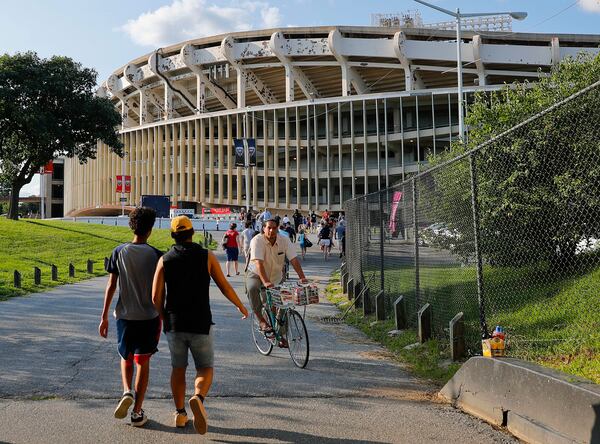 FILE - In this Aug. 5, 2017, file photo people make their way to RFK Stadium in Washington before an MLS soccer match between D.C. United and Toronto FC. (AP Photo/Pablo Martinez Monsivais, File)