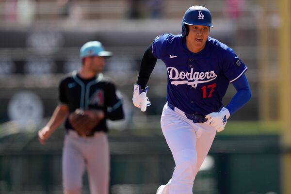 Los Angeles Dodgers' Shohei Ohtani runs to third on a base hit by Tommy Edman during the first inning of a spring training baseball game against the Arizona Diamondbacks, Monday, March 10, 2025, in Phoenix. (AP Photo/Matt York)