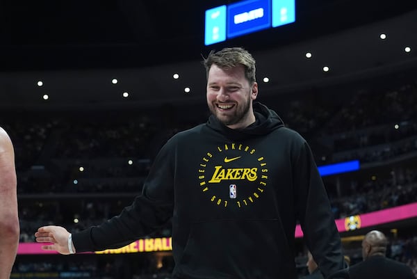 Los Angeles Lakers guard Luka Doncic heads back to the bench in the first half of an NBA basketball game against the Denver Nuggets, Friday, March 14, 2025, in Denver. (AP Photo/David Zalubowski)