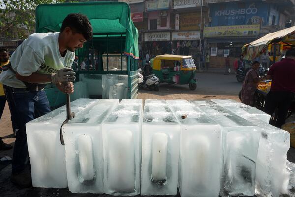 A man arranges ice blocks to sell at his stall in Ahmedabad, India, Wednesday, April 2, 2025. (AP Photo/Ajit Solanki)