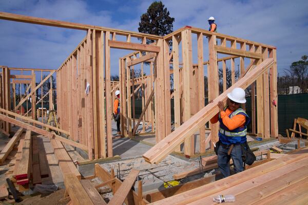 Workers rebuild a property destroyed by the Palisades Fire in the Pacific Palisades neighborhood of Los Angeles, Thursday, April 24, 2025. (AP Photo/Damian Dovarganes)