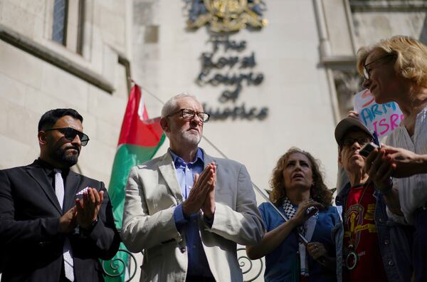 Britain's Member of Parliament Jeremy Corbyn, second left, joins demonstrators outside the Royal Courts of Justice, central London, where Palestinian human rights organization Al-Haq is taking legal action against the Department for Business and Trade over several decisions, Tuesday, May 13, 2025. (Ben Whitley/PA via AP)