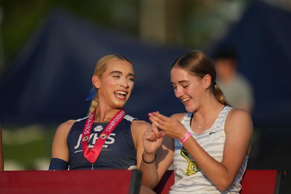 First-place winners AB Hernandez, left, and Jillene Wetteland share a light moment before the medal ceremony for the high jump at the California high school track-and-field championships in Clovis, Calif., Saturday, May 31, 2025. (AP Photo/Jae C. Hong)