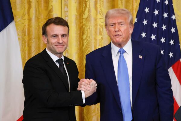 President Donald Trump, right, shakes the hand of France's President Emmanuel Macron during a joint press conference in the East Room of the White House in Washington, Monday, Feb. 24, 2025. (Ludovic Marin/Pool via AP)