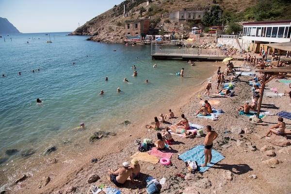 FILE - People gather at a beach in Balaklava Bay, part of Sevastopol on the Crimean Peninsula, Aug. 9, 2015. (AP Photo, File)