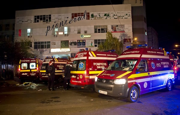 FILE - Ambulances are parked outside the site of a fire that occurred in a club, housed by the building in the background, in Bucharest, early Saturday, Oct. 31, 2015. (AP Photo/Vadim Ghirda, File)