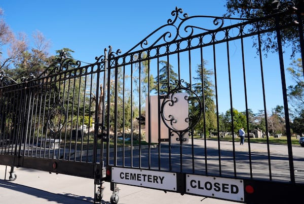 The entrance gate to the closed Mountain View Cemetery is pictured, Tuesday, Jan. 14, 2025, in Altadena, Calif. (AP Photo/Chris Pizzello)