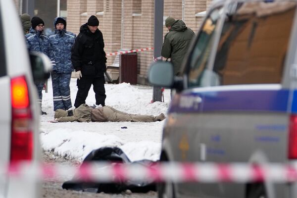 Investigators work at the place where Lt. General Igor Kirillov, the head of Russia's Nuclear, Biological, and Chemical Defence Forces and his assistant, seen on center, were killed by an explosive device planted close to a residential apartment's block in Moscow, Russia, Tuesday, Dec. 17, 2024. (AP Photo)