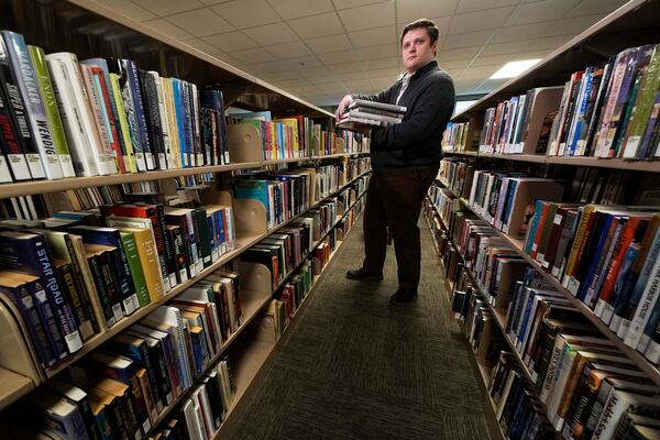 Spencer Davis, one of several librarians slated to be laid off due to DOGE cuts, works at the Maine State Library, Wednesday, May 7, 2025, in Augusta, Maine. (AP Photo/Robert F. Bukaty)