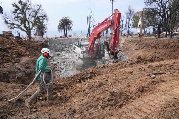 Construction begins on a property damaged by the Palisades Fire in the Pacific Palisades neighborhood of Los Angeles Thursday, April 24, 2025. (AP Photo/Damian Dovarganes)