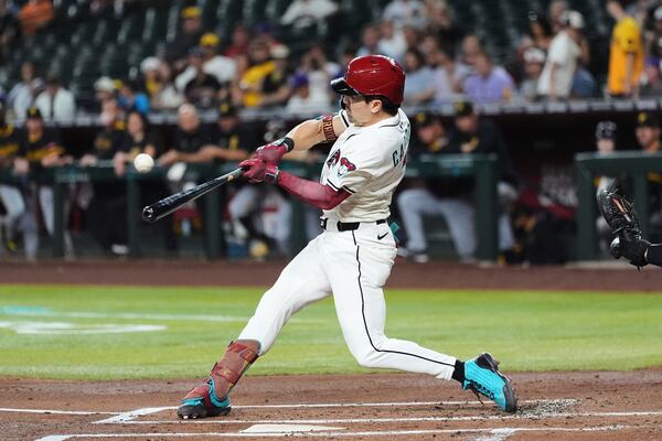 Arizona Diamondbacks' Corbin Carroll connects for a home run against the Pittsburgh Pirates during the first inning of a baseball game Tuesday, May 27, 2025, in Phoenix. (AP Photo/Ross D. Franklin)
