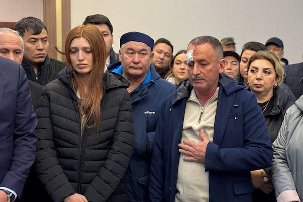 This photo provided by the administration of the Mangystau region of Kazakhstan shows a group of surviving passengers of the crashed Azerbaijan Airlines Embraer 190 prior to departure to Baku at the airport of Aktau, Kazakhstan, on Thursday, Dec. 26, 2024. (Administration of the Mangystau Region via AP)