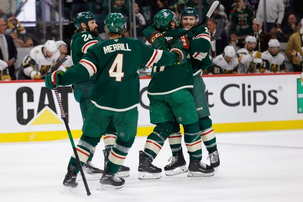 Minnesota Wild right wing Ryan Hartman, right, celebrates with teammates after scoring during the first period of Game 6 of a first-round NHL hockey playoff series against the Vegas Golden Knights, Thursday, May 1, 2025, in St. Paul, Minn. (AP Photo/Bailey Hillesheim)