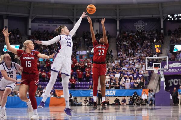 Louisville's Tajianna Roberts (22) shoots as TCU's Sedona Prince (13) defends in the first half in the second round of the NCAA college basketball tournament in Fort Worth, Texas, Sunday, March 23, 2025. (AP Photo/Tony Gutierrez)