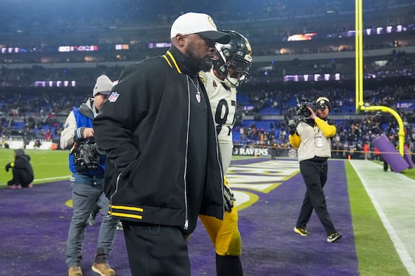 Pittsburgh Steelers head coach Mike Tomlin, center, walks off the field with defensive tackle Cameron Heyward (97) following an NFL wild-card playoff football game against the Baltimore Ravens, Saturday, Jan. 11, 2025, in Baltimore. The Ravens won 28-14. (AP Photo/Stephanie Scarbrough)