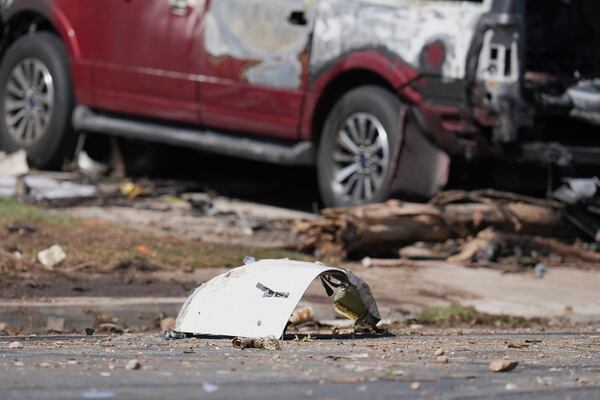 Debris covers the ground after a small plane crashed into a San Diego neighborhood earlier, setting several homes on fire and forcing evacuations along several blocks early Thursday, May 22, 2025. (AP Photo/Gregory Bull)