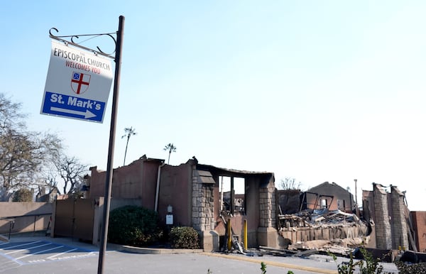 A welcome sign points to the charred remains of St. Mark's Episcopal Church after it was destroyed by the Eaton Fire, Friday, Jan. 10, 2025, in Altadena, Calif. (AP Photo/Chris Pizzello)