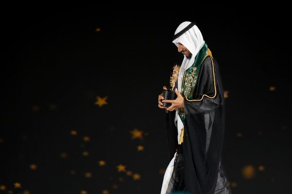 Saudi Arabian teacher Mansour bin Abdullah Al-Mansour, walks off the stage after receiving the Global Teacher Prize trophy from Dubai Crown Prince Sheikh Hamdan bin Mohammed Al Maktoum at a ceremony in Dubai, United Arab Emirates, Thursday, Feb. 13, 2025. (AP Photo/Altaf Qadri)