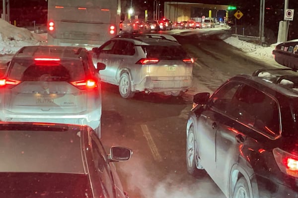 Cars are backed up at the US-Canada border in Stanstead, Quebec, after a shooting involving a U.S. Border Patrol agent in Coventry, Vt., Monday, Jan. 20, 2025. (AP Photo/Chloe Jones)