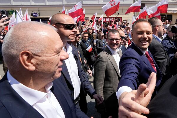 Conservative presidential candidate Karol Nawrocki, front right, takes part in a march one week ahead of a decisive election in Warsaw Poland on Sunday, May 25, 2025. (AP Photo/Czarek Sokolowski)