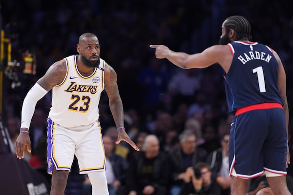 Los Angeles Lakers forward LeBron James, left, watches Los Angeles Clippers guard James Harden as he gestures during the second half of an NBA basketball game Sunday, March 2, 2025, in Los Angeles. (AP Photo/Mark J. Terrill)