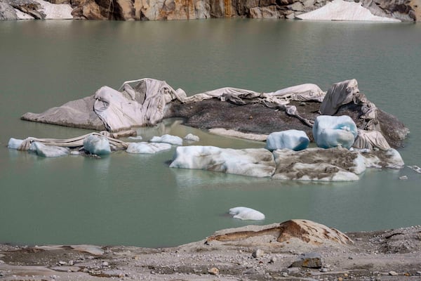 FILE - Chunks of ice float in a lake in front of Rhone Glacier near Goms, Switzerland, June 15, 2023. (AP Photo/Matthias Schrader, File)