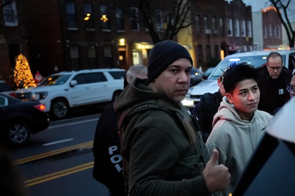 Deportation officers with Enforcement and Removal Operations in U.S. Immigration and Customs Enforcement's New York City field office arrest Wilmer Patricio Medina-Medina during an early morning operation, Tuesday, Dec. 17, 2024, in the Bronx borough of New York. (AP Photo/Julia Demaree Nikhinson)