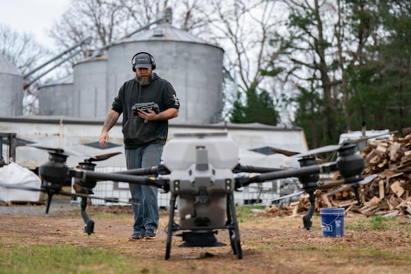 Russell Hedrick prepares a DJI drone to put crop cover on his farm, Tuesday, Dec. 17, 2024, in Hickory, N.C. (AP Photo/Allison Joyce)