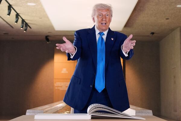 President Donald Trump talks before signing guest book at the Abrahamic Family House, Friday, May 16, 2025, in Abu Dhabi, United Arab Emirates. (AP Photo/Alex Brandon)