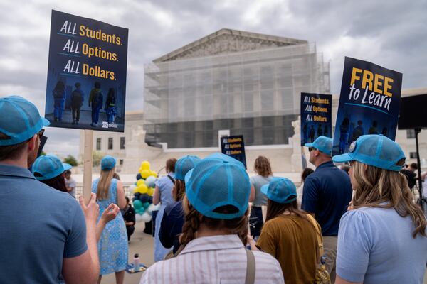 Supporters of charter schools rally outside of the Supreme Court on Wednesday, April 30, 2025, in Washington. (AP Photo/Mark Schiefelbein)