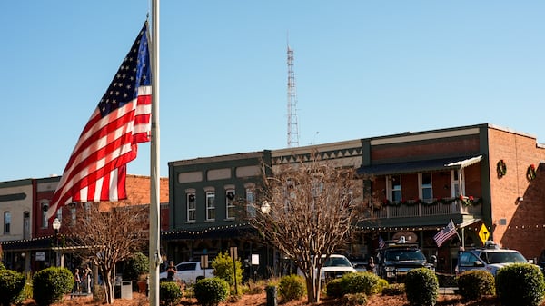 A flag flies at half-staff on main street in the aftermath of former President Jimmy Carter's death, Monday, Dec. 30, 2024, in Plains, Ga. Carter died Sunday at the age of 100.(AP Photo/Mike Stewart)