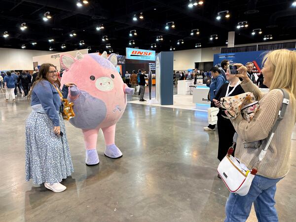 Berkshire Hathaway shareholders pose for photos with life-size Squishmallows ahead of Saturday's annual meeting with Warren Buffett on Friday, May 2, 2025 in Omaha, Neb. (AP Photo/Josh Funk)