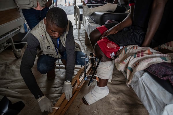 Medics treat a man wounded during fighting between Congolese government troops and M23 rebel forces in Goma's Kyeshero hospital Saturday, Feb. 1, 2025. (AP Photo/Moses Sawasawa)