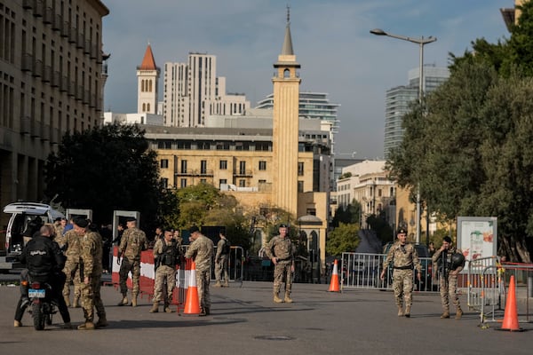 Lebanese army soldiers block a road that leads to the parliament building while lawmakers gather to elect a president in Beirut, Lebanon, Thursday, Jan. 9, 2025. (AP Photo/Bilal Hussein)