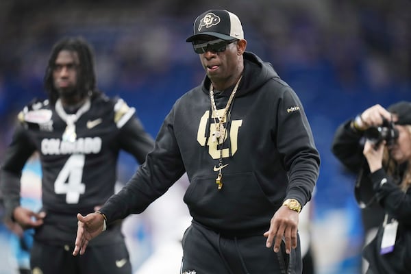 Colorado head coach Deion Sanders watches his players warm up for the Alamo Bowl NCAA college football game against BYU, Saturday, Dec. 28, 2024, in San Antonio. (AP Photo/Eric Gay)