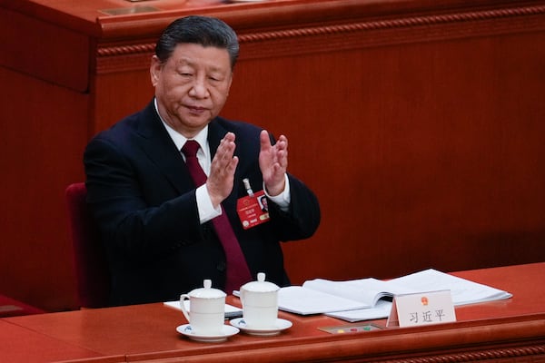 Chinese President Xi Jinping applauds during the opening session of the National People's Congress (NPC) at the Great Hall of the People in Beijing, China, Wednesday, March 5, 2025. (AP Photo/Andy Wong)