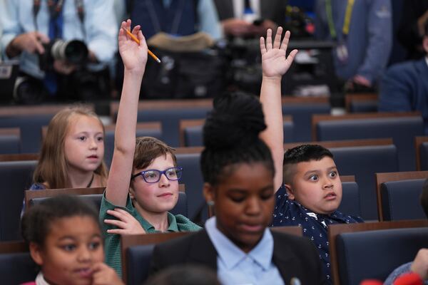 Children raise their hands as White House press secretary Karoline Leavitt speaks during a briefing for "Take Our Sons and Daughters To Work Day" at the White House, Tuesday, May 20, 2025, in Washington. (AP Photo/Evan Vucci)
