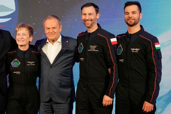 U.S. astronaut Peggy Whitson, commander of the Ax-4 space mission, left, Poland's Prime Minister Donald Tusk, center, Polish member of the mission crew, astronaut Slawosz Uznanski-Wisniewski, and Tibor Kapu of Hungary, right, pose during a media event dedicated to the preparations for the mission, at the Copernicus Science Center in Warsaw, Poland, Wednesday, Feb. 5, 2025. (AP Photo/Czarek Sokolowski)