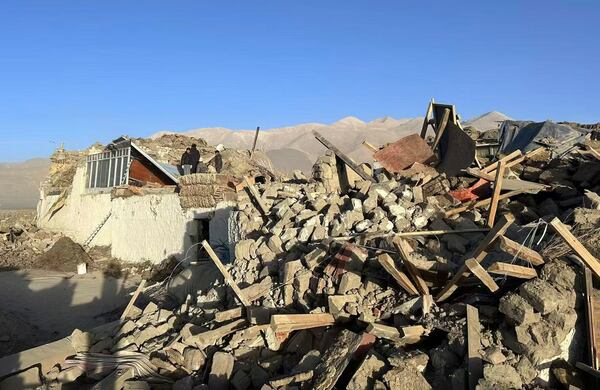 In this photo released by Xinhua News Agency, people stand amidst damaged houses in the aftermath of an earthquake in Tonglai Village, Changsuo Township of Dingri in Xigaze, southwestern China's Tibet Autonomous Region on Tuesday, Jan. 7, 2025. (Xinhua via AP)