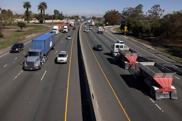 A picture shot from a bridge overlooking the 710 highway shows the traffic going in and out of the Ports of Los Angeles and Long Beach, Monday, March 10, 2025, in Long Beach, Calif. (AP Photo/Etienne Laurent)