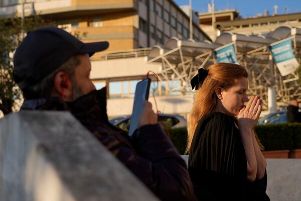 Michelle Van Asperen, of the Netherlands, prays for Pope Francis outside the Agostino Gemelli Polyclinic in Rome, Tuesday, March 4, 2025. (AP Photo/Gregorio Borgia)