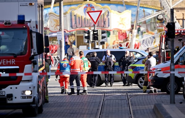 Police and emergency services are deployed during a major operation in the city center of Mannheim, Germany, Monday March 3, 2025, following an incident in which one person was killed and others injured when a car rammed into a crowd, German police said. (Boris Roessler/dpa via AP)