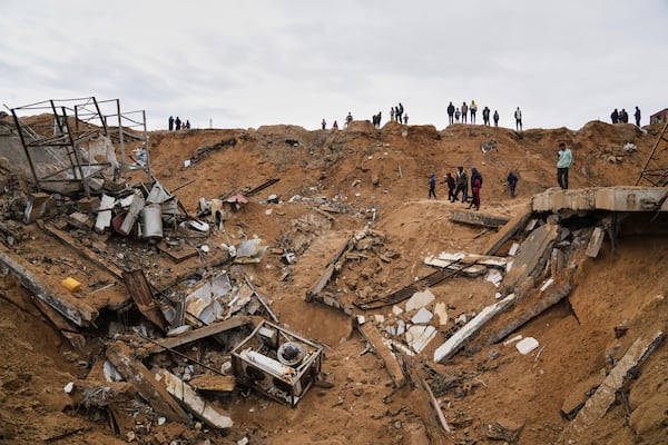 Palestinians inspect the rubble of a structure hit by an Israeli bombardment in Deir al-Balah, Gaza Strip on Saturday, March 22, 2025. (AP Photo/Abdel Kareem Hana)