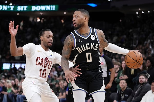 Milwaukee Bucks' Damian Lillard tries to get past Cleveland Cavaliers' Darius Garland during the first half of an NBA basketball game Sunday, Mar. 9, 2025, in Milwaukee. (AP Photo/Morry Gash)