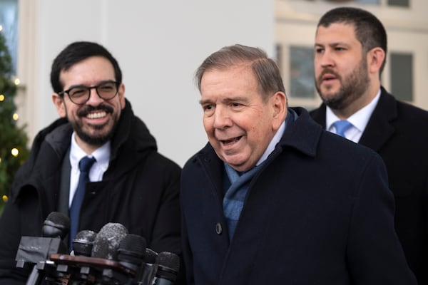 Venezuela's opposition leader Edmundo Gonzalez, center, speaks with reporters at the White House, Monday, Jan. 6, 2025, in Washington. (AP Photo/Mark Schiefelbein)