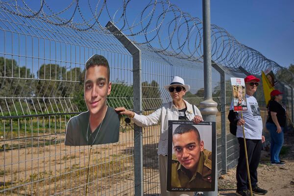 FILE - Varda Ben Baruch, holds a picture of her grandson Edan Alexander who is held hostage in Gaza, near the Gaza border in Kibbutz Nir Oz, southern Israel, on April 20, 2025. (AP Photo/Ohad Zwigenberg, File)