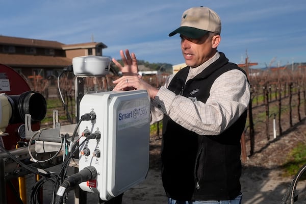 Tyler Klick, Partner/Viticulturist of Redwood Empire Vineyard Management, discusses using NovAtel LiDAR technology, shown at top, and a Smart Apply Intelligent Spray Control System, bottom, during an interview in Geyserville, Calif., Friday, Jan. 24, 2025. (AP Photo/Jeff Chiu)