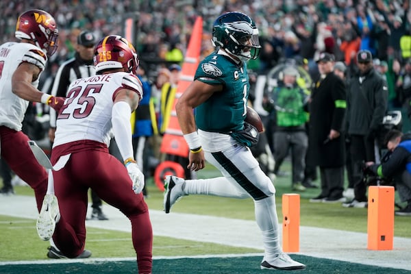 Philadelphia Eagles quarterback Jalen Hurts scores against the Washington Commanders during the second half of the NFC Championship NFL football game, Sunday, Jan. 26, 2025, in Philadelphia. (AP Photo/Seth Wenig)