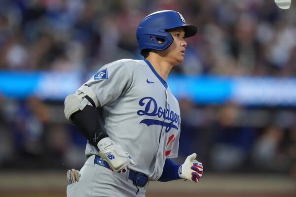 Los Angeles Dodgers' Shohei Ohtani, of Japan, reacts after hitting a line out to center field during the third inning of a baseball game against the New York Mets Saturday, May 24, 2025, in New York. (AP Photo/Frank Franklin II)
